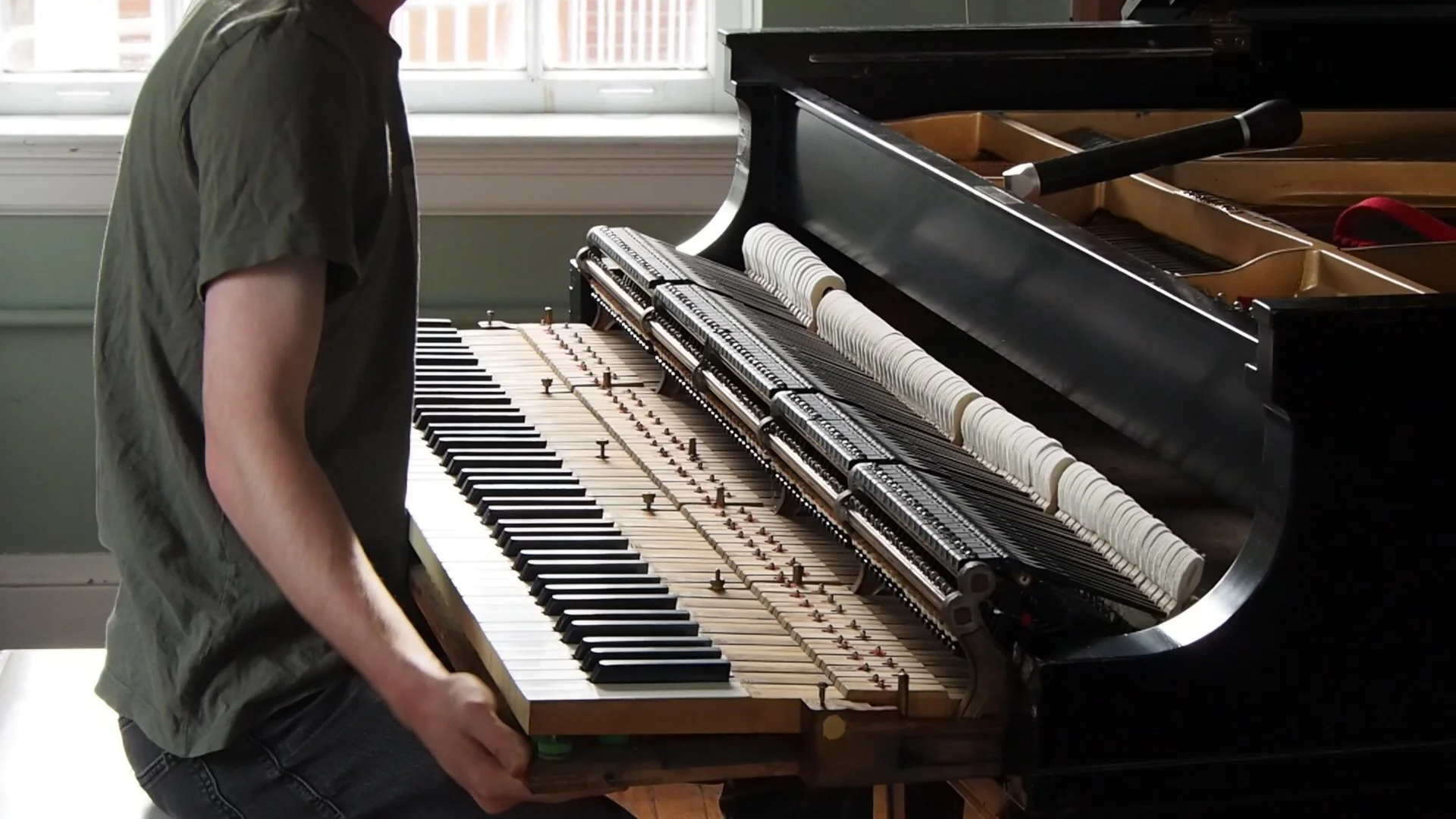 Brendan Coller removing the action from a Steinway grand piano