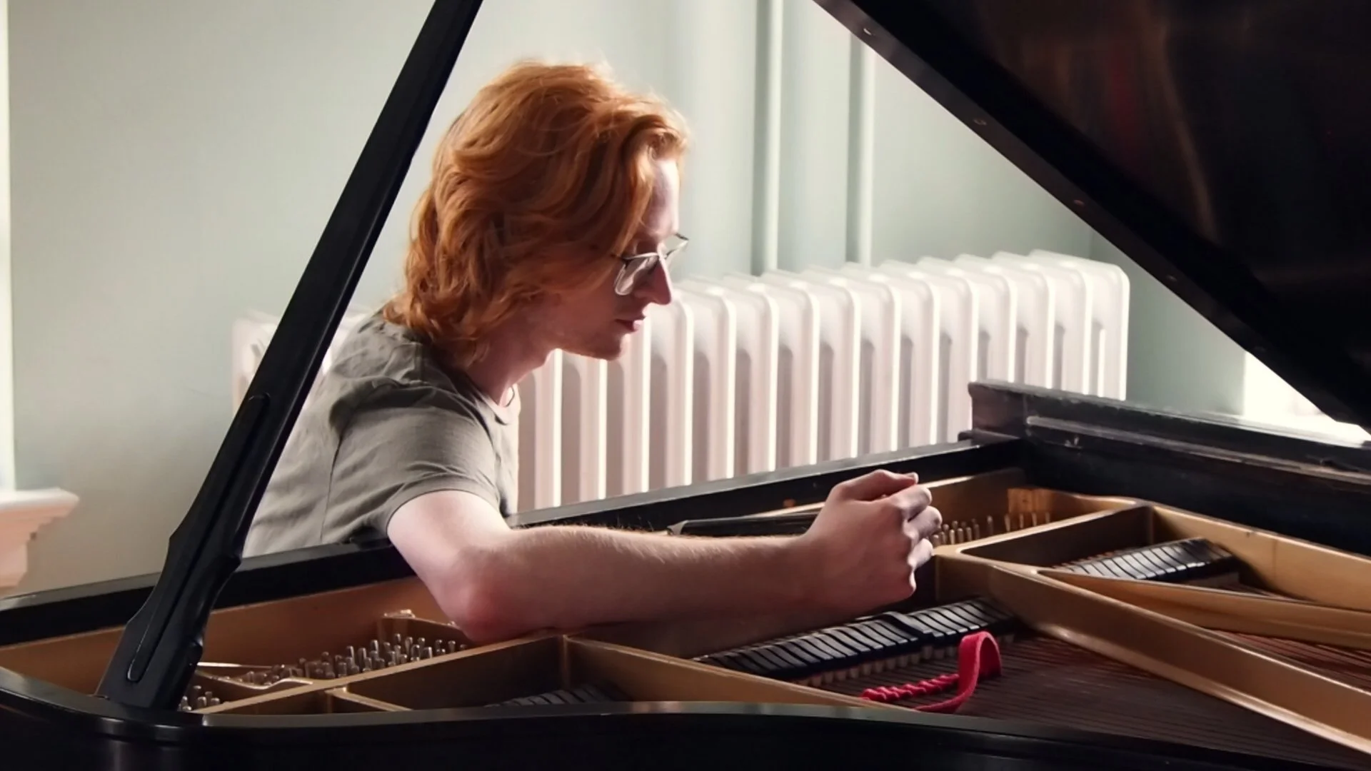 Brendan Coller tuning a Steinway grand piano