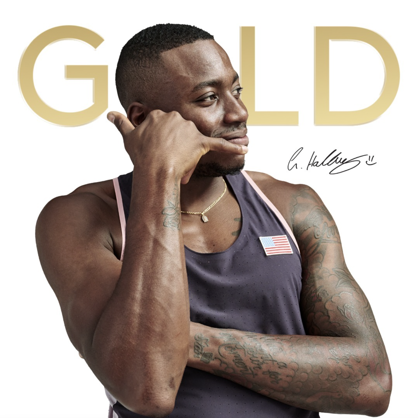 A male athlete in a purple sleeveless top with an American flag patch, smiling and posing with his left arm crossed, touching his chin with his right hand. The background features large gold text spelling 'GOLD' and a signature.
