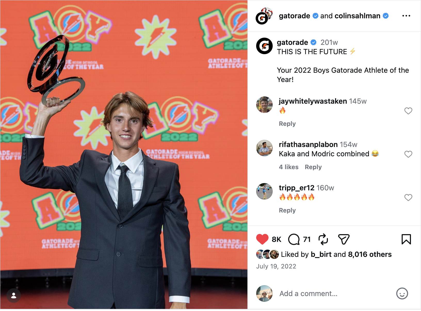 A young man in a suit holding a trophy at an awards ceremony with a colorful background featuring the Gatorade athlete of the year logo.