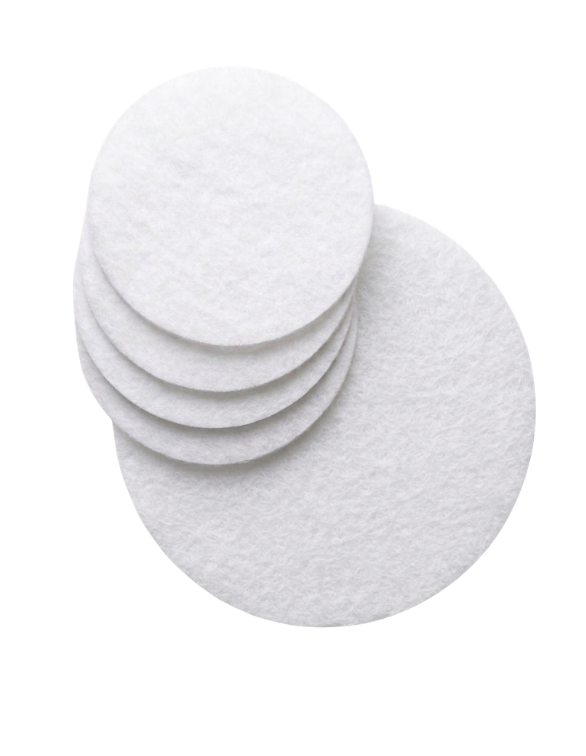 Six white disinfectant wipes stacked on top of each other with one wipe laid flat in front.
