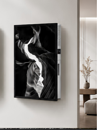 A flat-screen television mounted on a white wall, displaying a black-and-white abstract image.