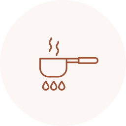 A steaming coffee cup with a handle, on a small stand with three drops beneath it.