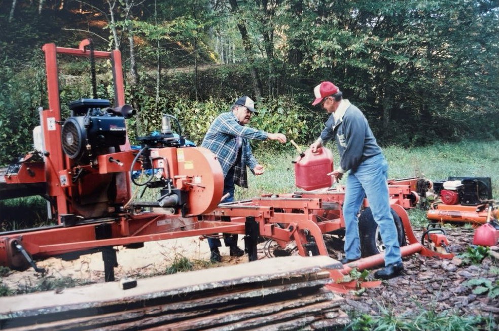 ~2000 - Lumber being planed by the Spring Creek community to use in the restoration of the Spring Creek School. The community donated their time and expertise, along with use of equipment, trees, and fuel. 