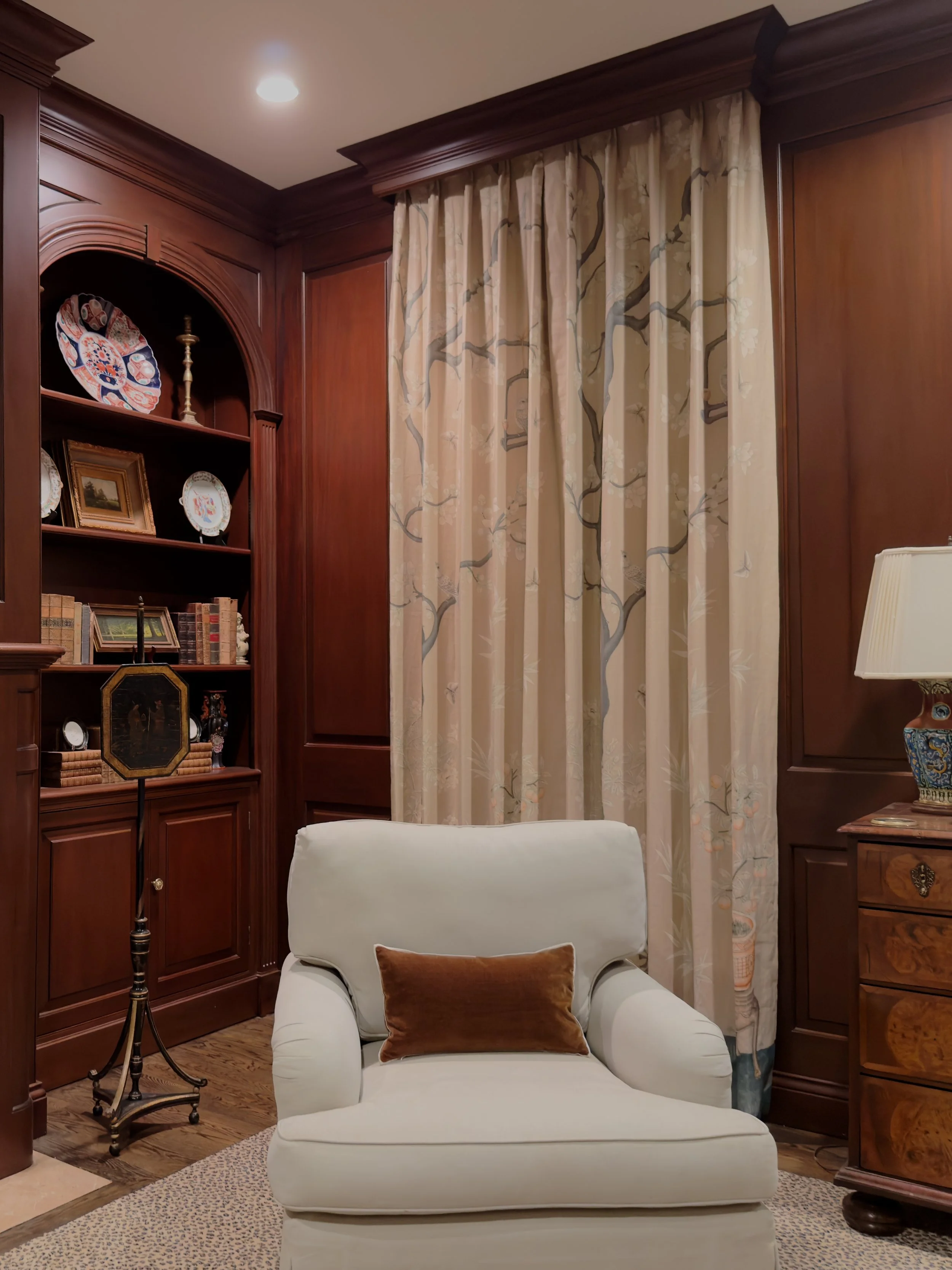 Bespoke library with custom millwork, built-in shelves, and designer Gracie drapery in Louisville KY by Susan Harreld Interiors