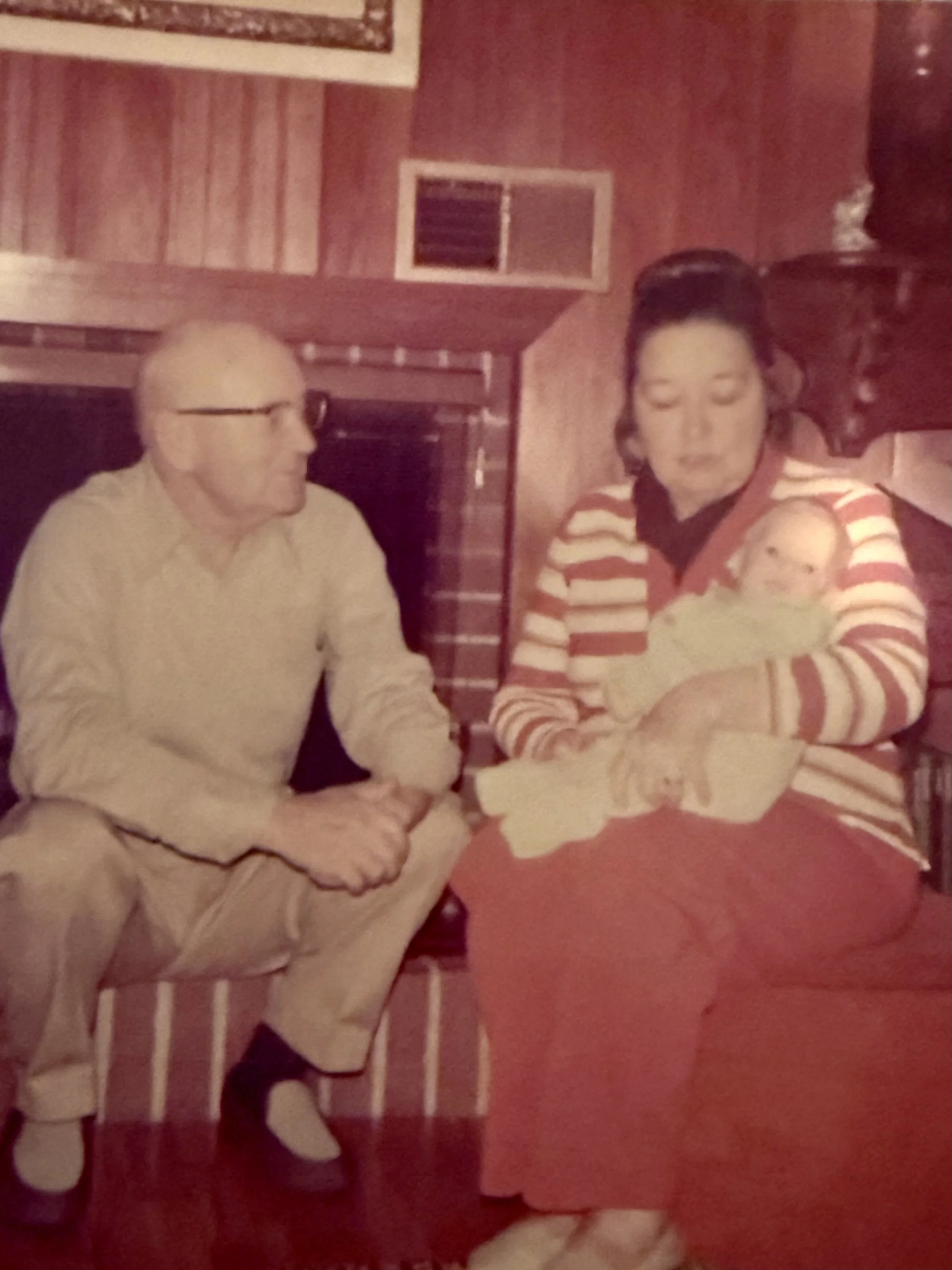 grandparents holding baby