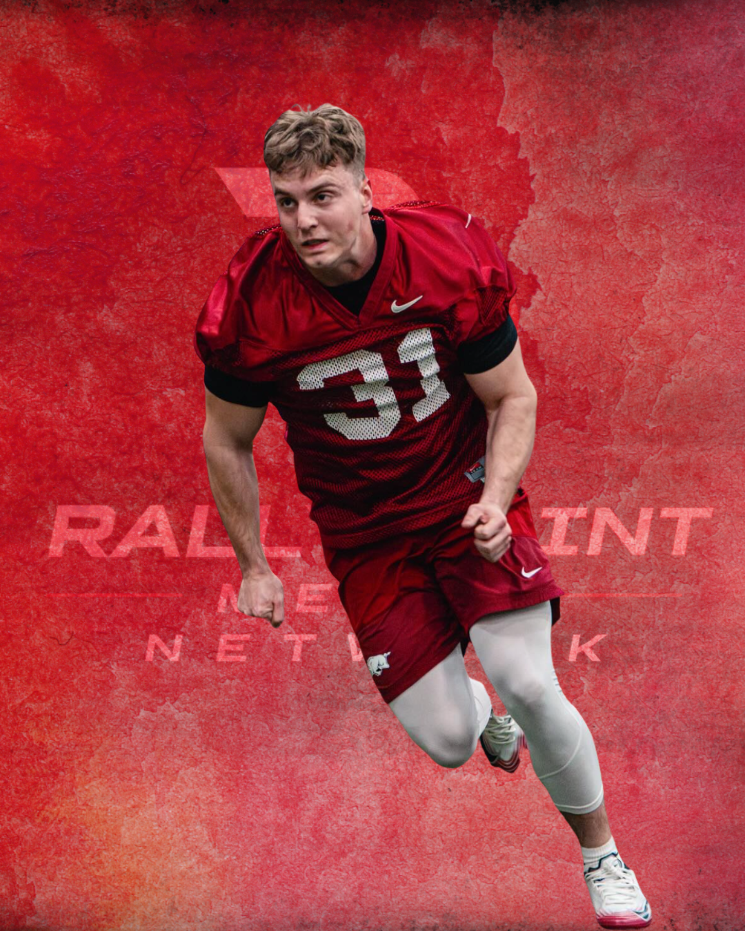 A football player wearing a red uniform and white leggings, running with a determined expression, against a red textured background with the words 'RALL' and 'NET' faintly visible.