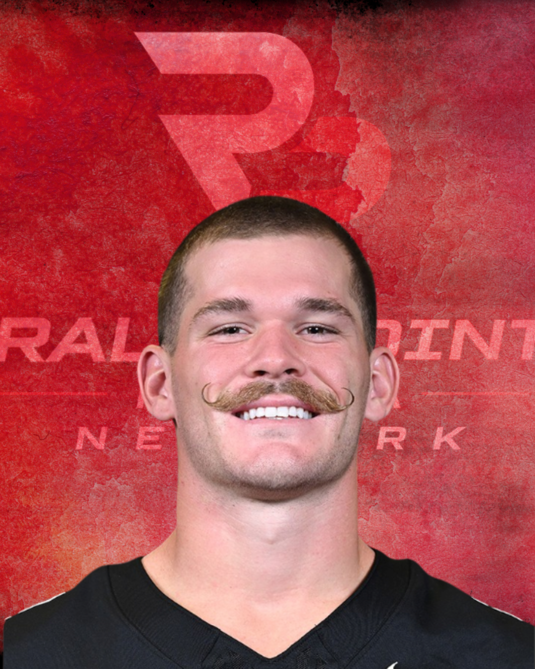 Portrait of a young man with a mustache smiling, with a red textured background featuring the letters R and NET in the background.