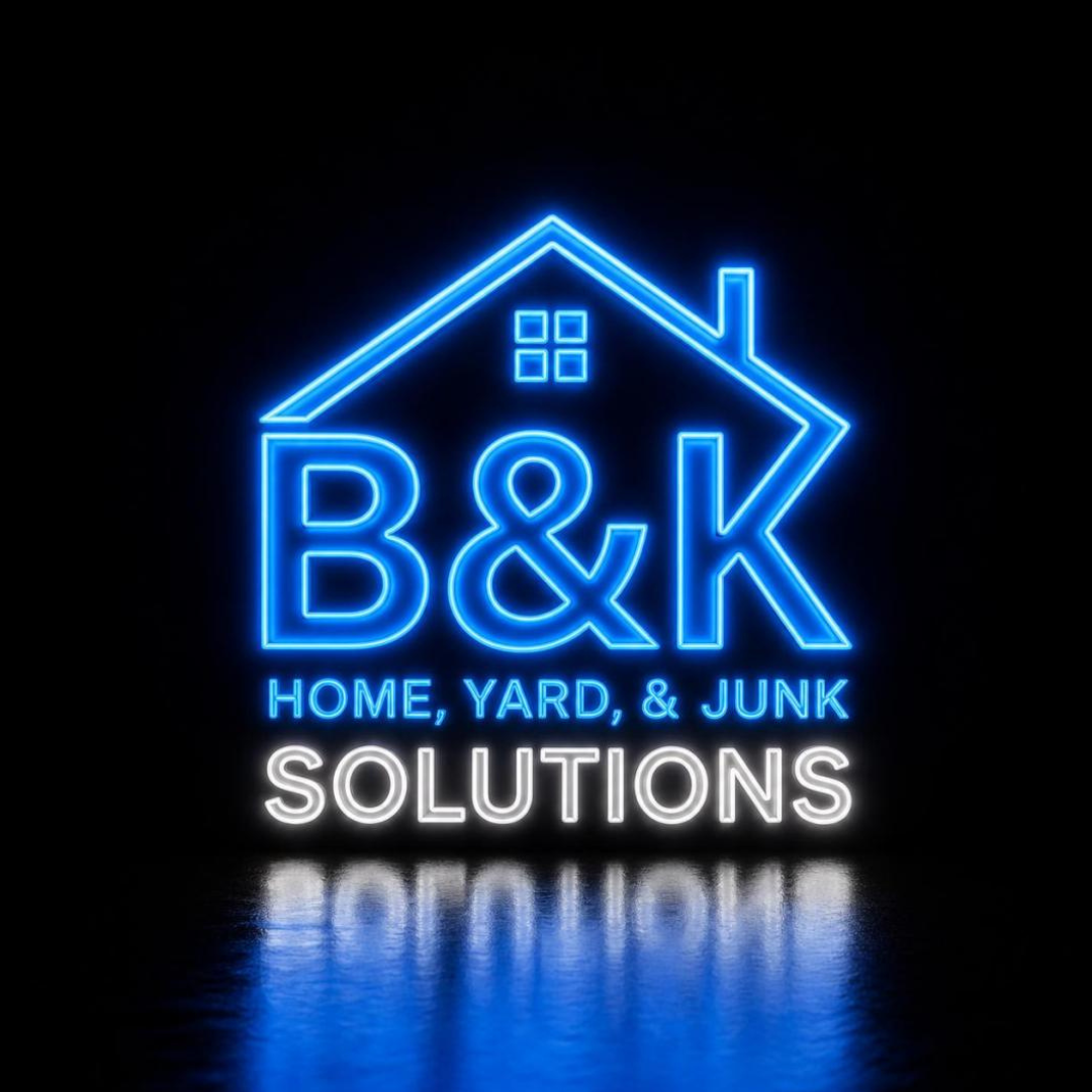 Neon sign for B&K Home, Yard, & Junk Solutions with a house outline, blue and white lighting, and a reflection on the ground.