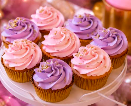 Cupcakes with pink and purple frosting on a white cake stand.