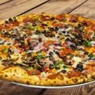 A pizza topped with various ingredients including black olives, green peppers, and melted cheese.