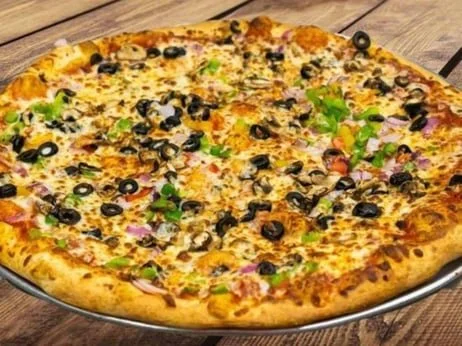 A large pizza topped with black olives, green peppers, red onions, and cheese.