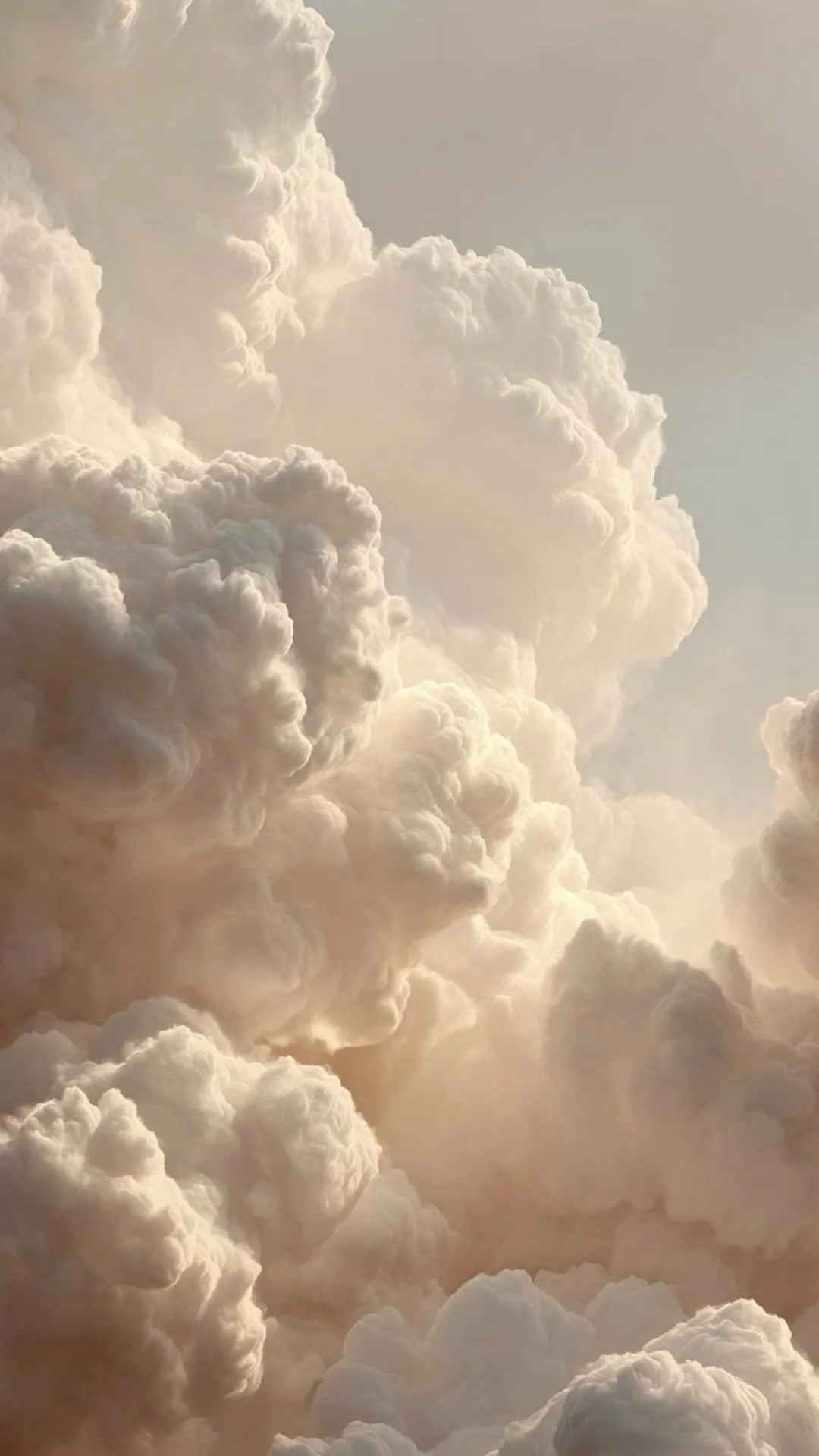 A sky filled with large, billowing, fluffy clouds illuminated by sunlight.
