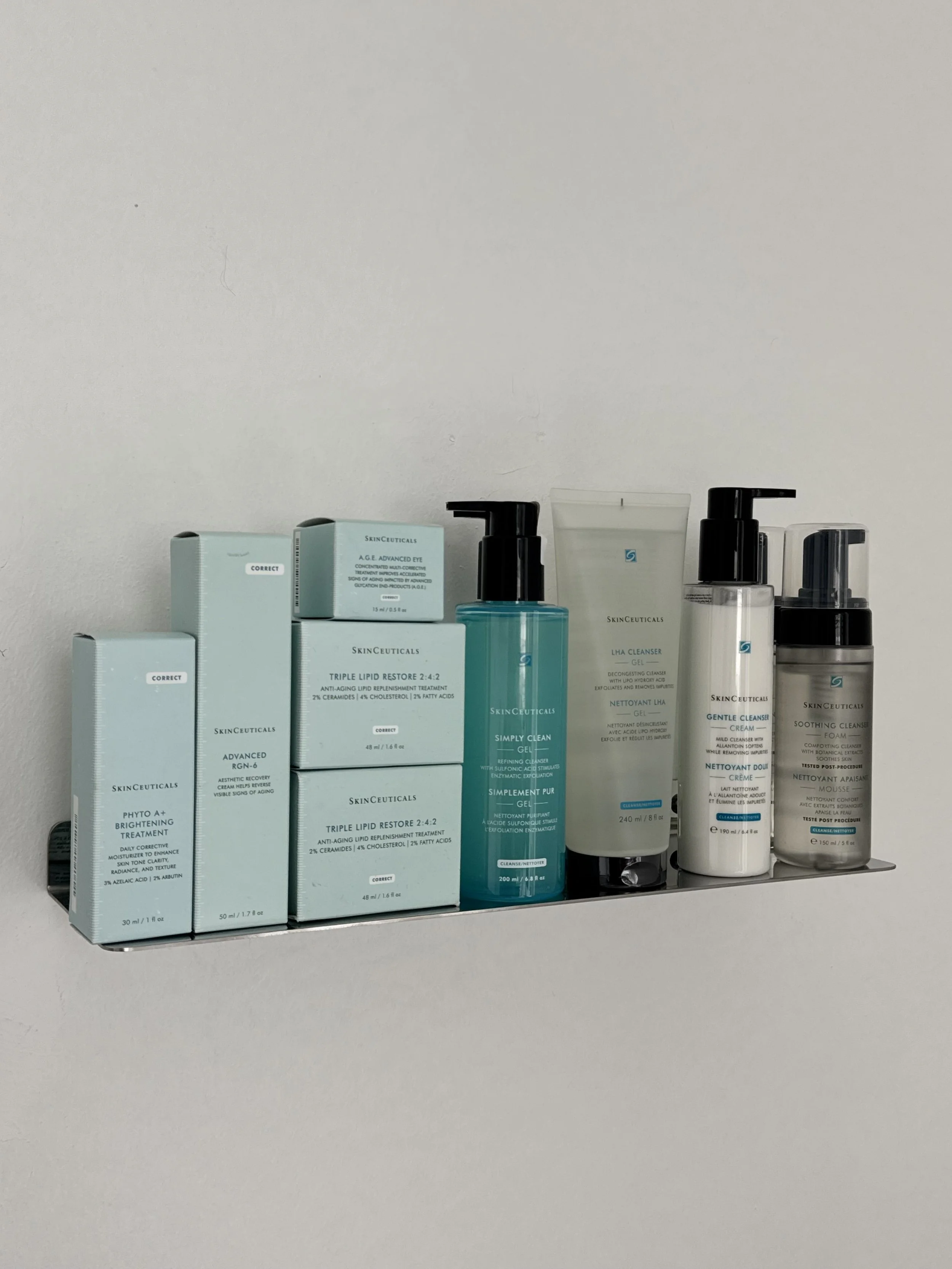 Collection of skincare products including cleansers, toners, and treatments arranged on a shelf.