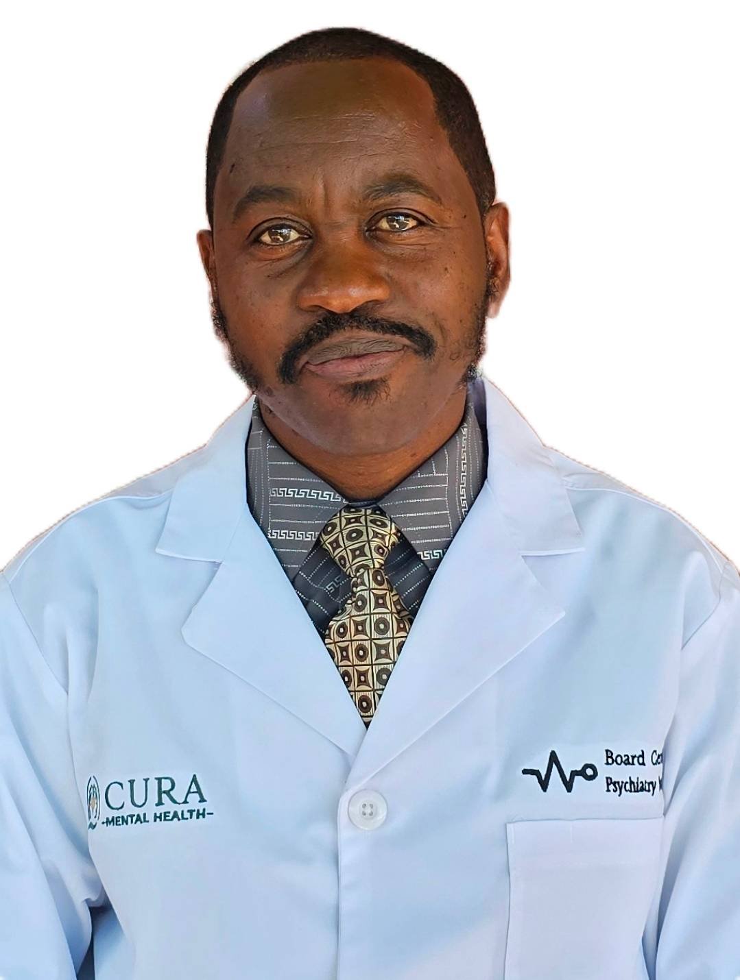 A man with dark hair, mustache, and beard wearing a light blue lab coat with 'CURA Mental Health' and 'Board Certified Psychiatry' logos, a patterned shirt, and a decorative tie, against a plain white background.