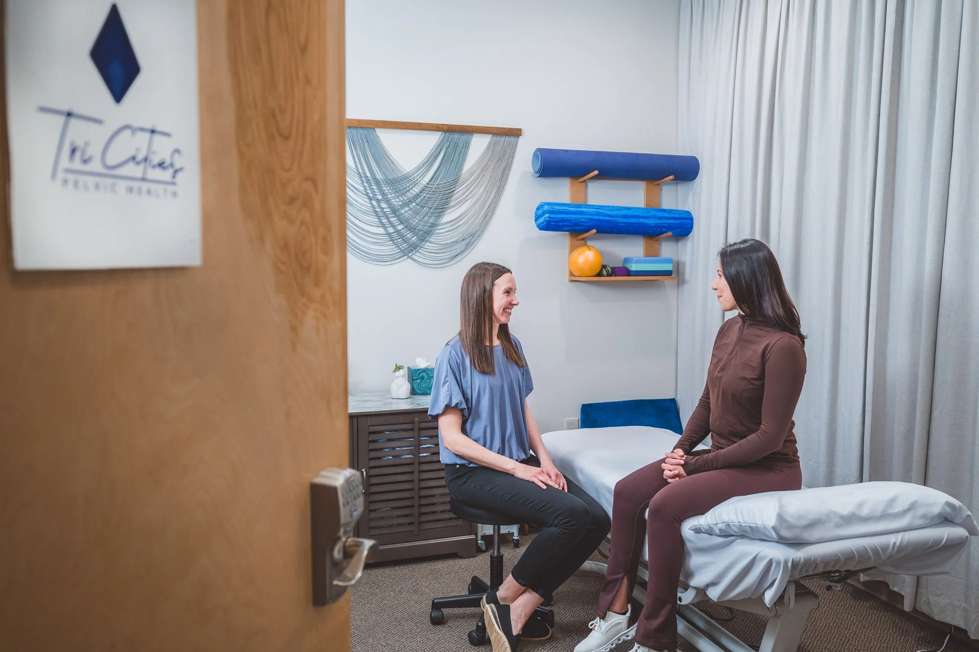 pelvic therapist talking to a patient during an evaluation