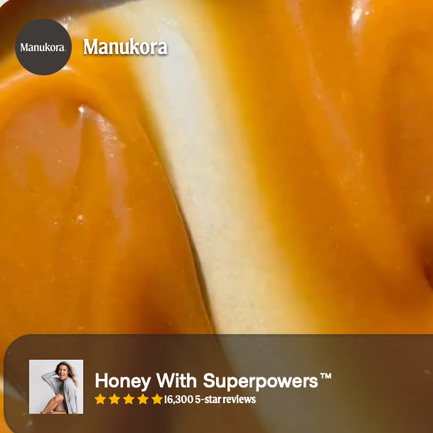Close-up of a honeycomb with golden honey flowing over it.