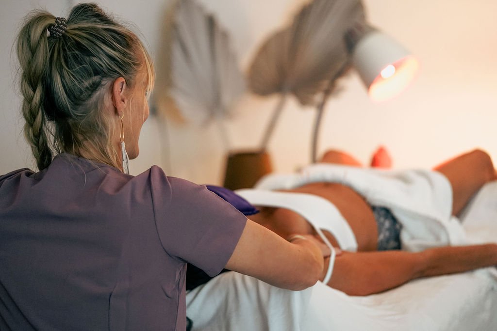 A healthcare worker tending to a patient lying in a hospital bed