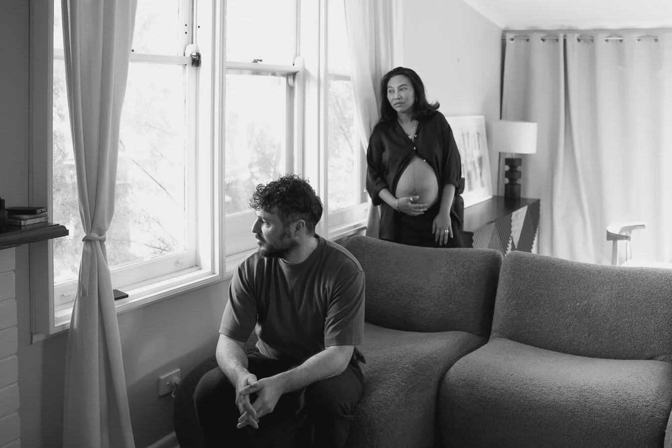Expectant parents photographed in their home during a lifestyle maternity photography session in Melbourne before welcoming their baby.