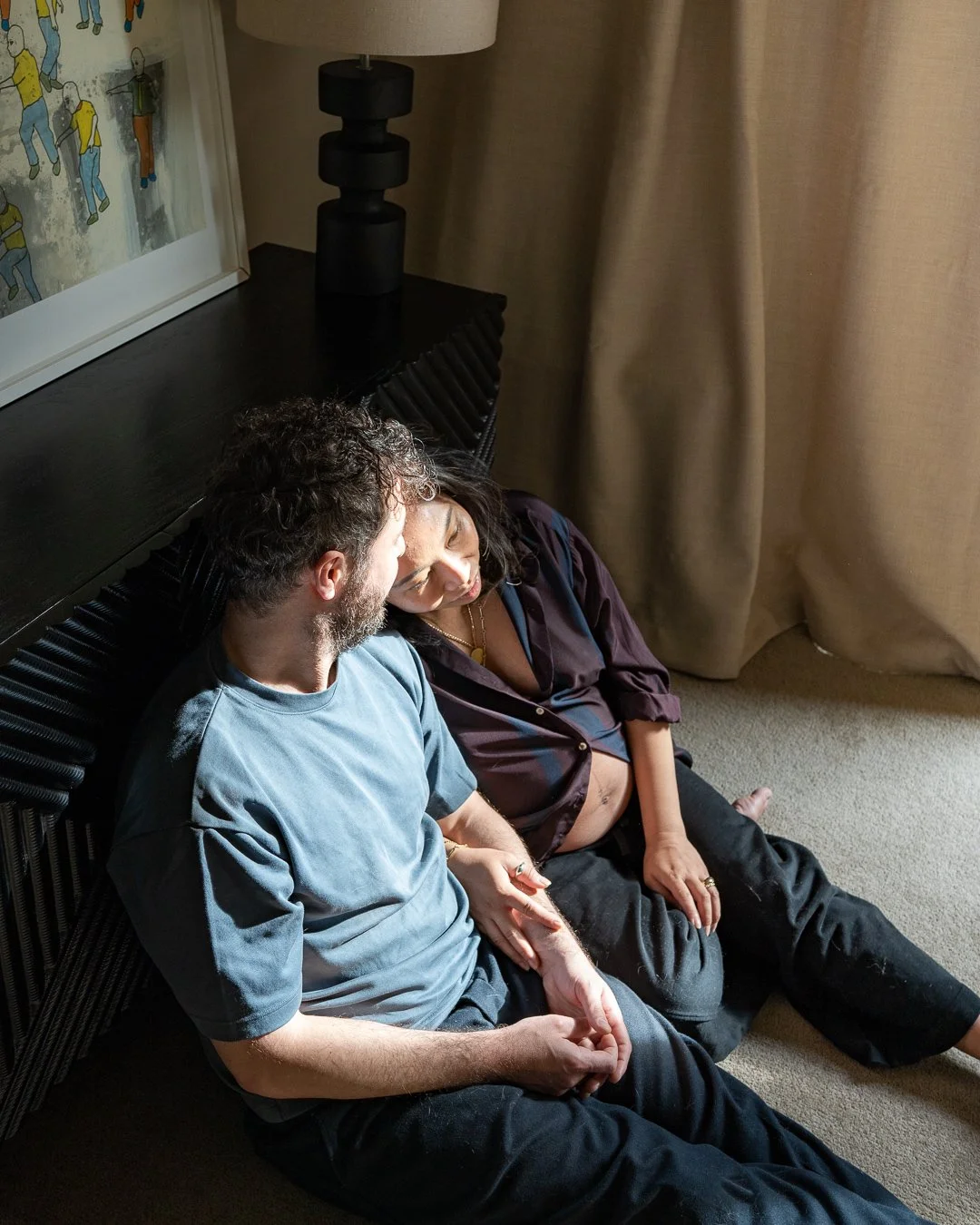 Expectant couple sharing a quiet moment together during an in-home maternity photography session in Rosanna, Melbourne.