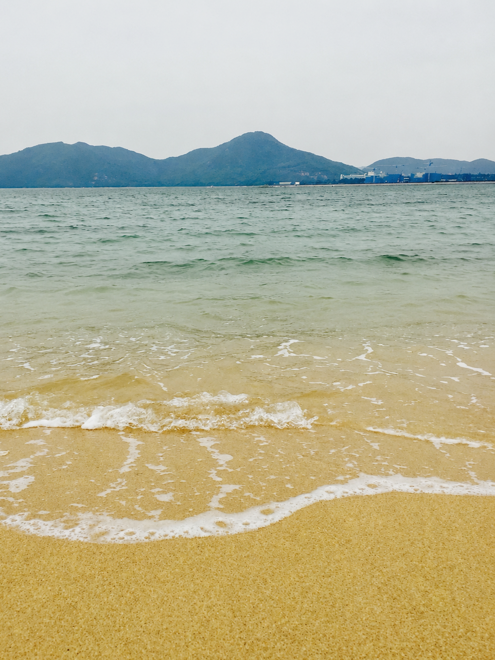 Gentle ocean waves along a quiet shoreline, symbolizing nervous system regulation, grounding, and restoration.