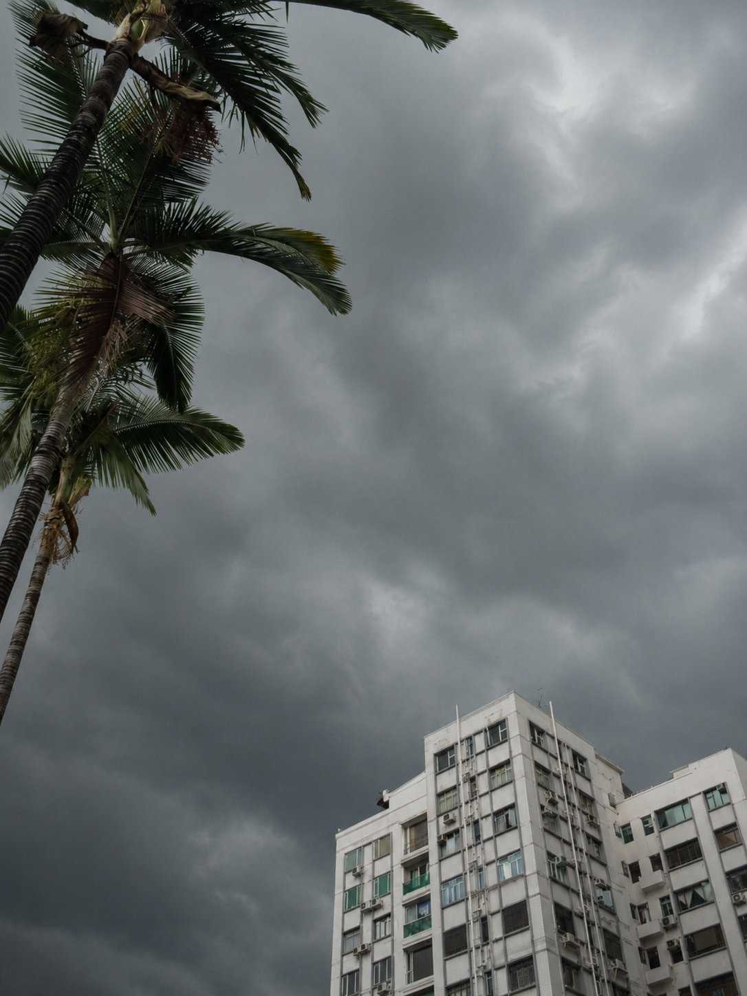 Dark storm clouds gathering over a residential building, symbolizing the heaviness and emotional weight often experienced with depression and low mood.