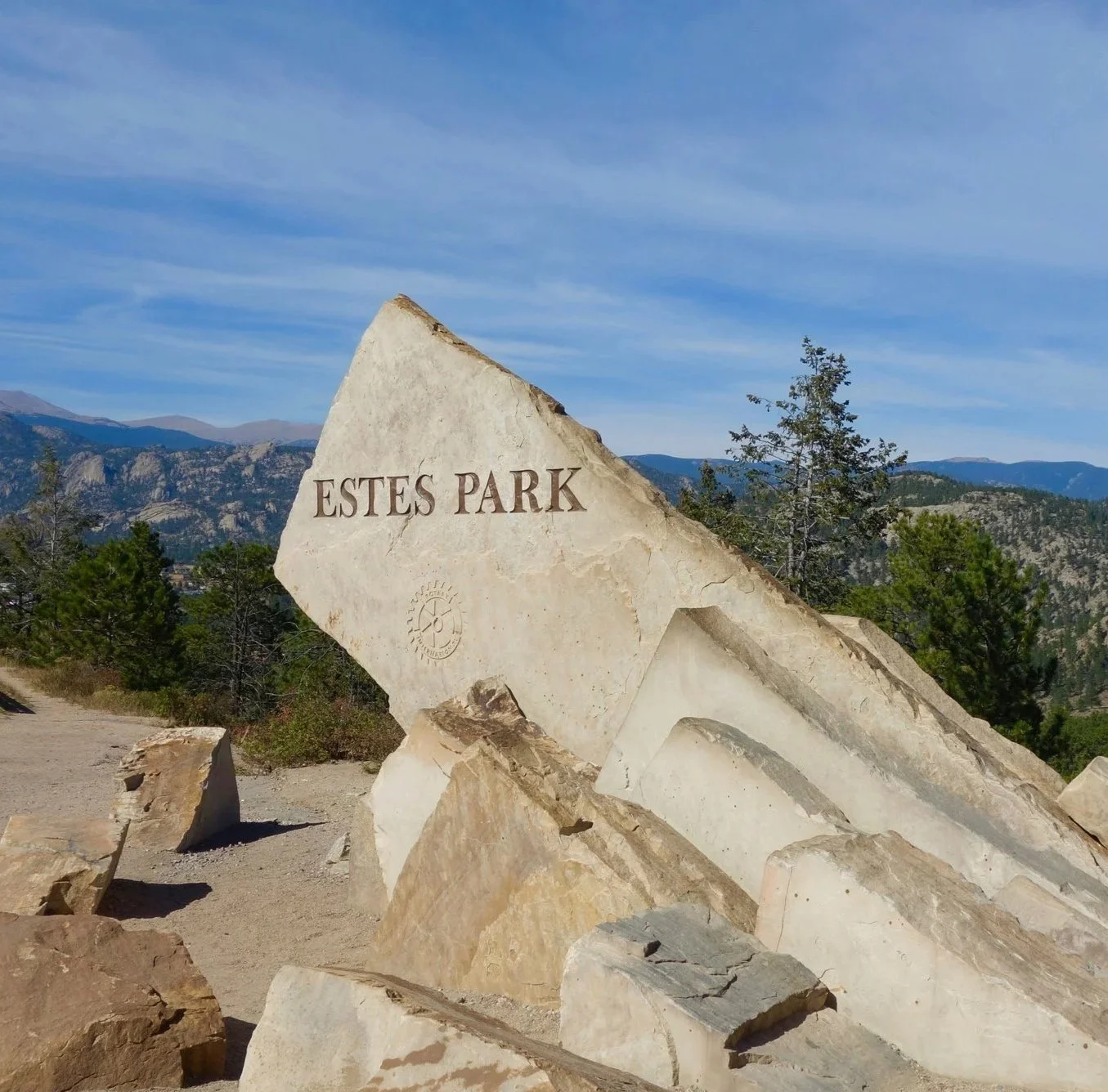 Welcome to Estes Park, Colorado sign at the entrance to the mountain community where PLAKE Law is located.