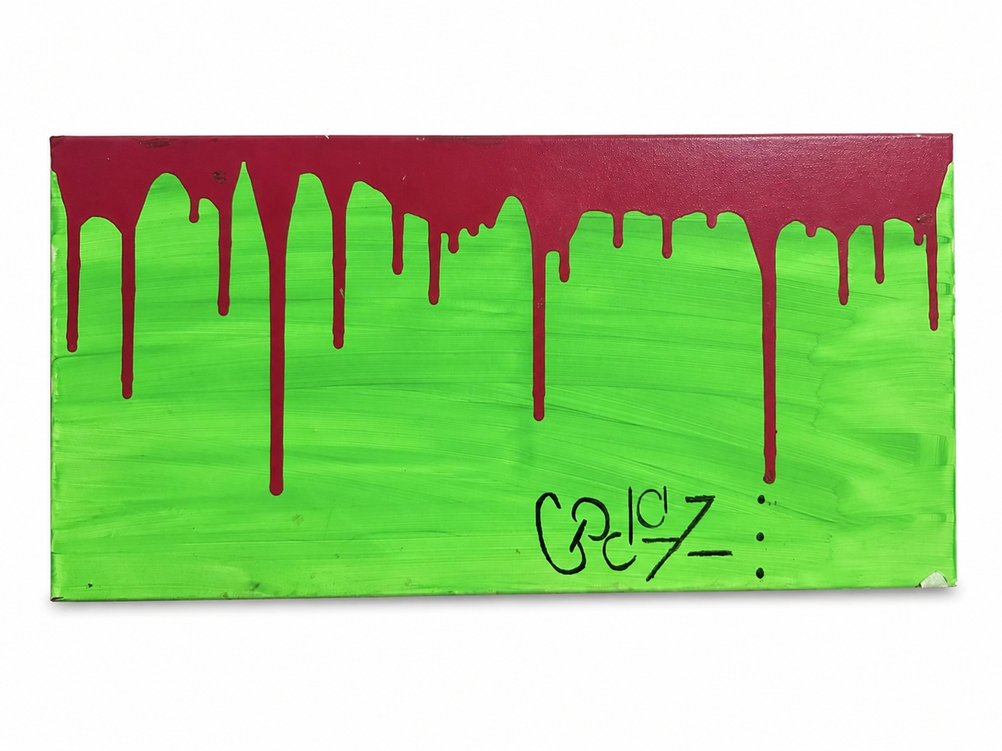 A painted cardboard box with green and red paint, featuring red drips down from the top and the text 'Zeidz' written on it.