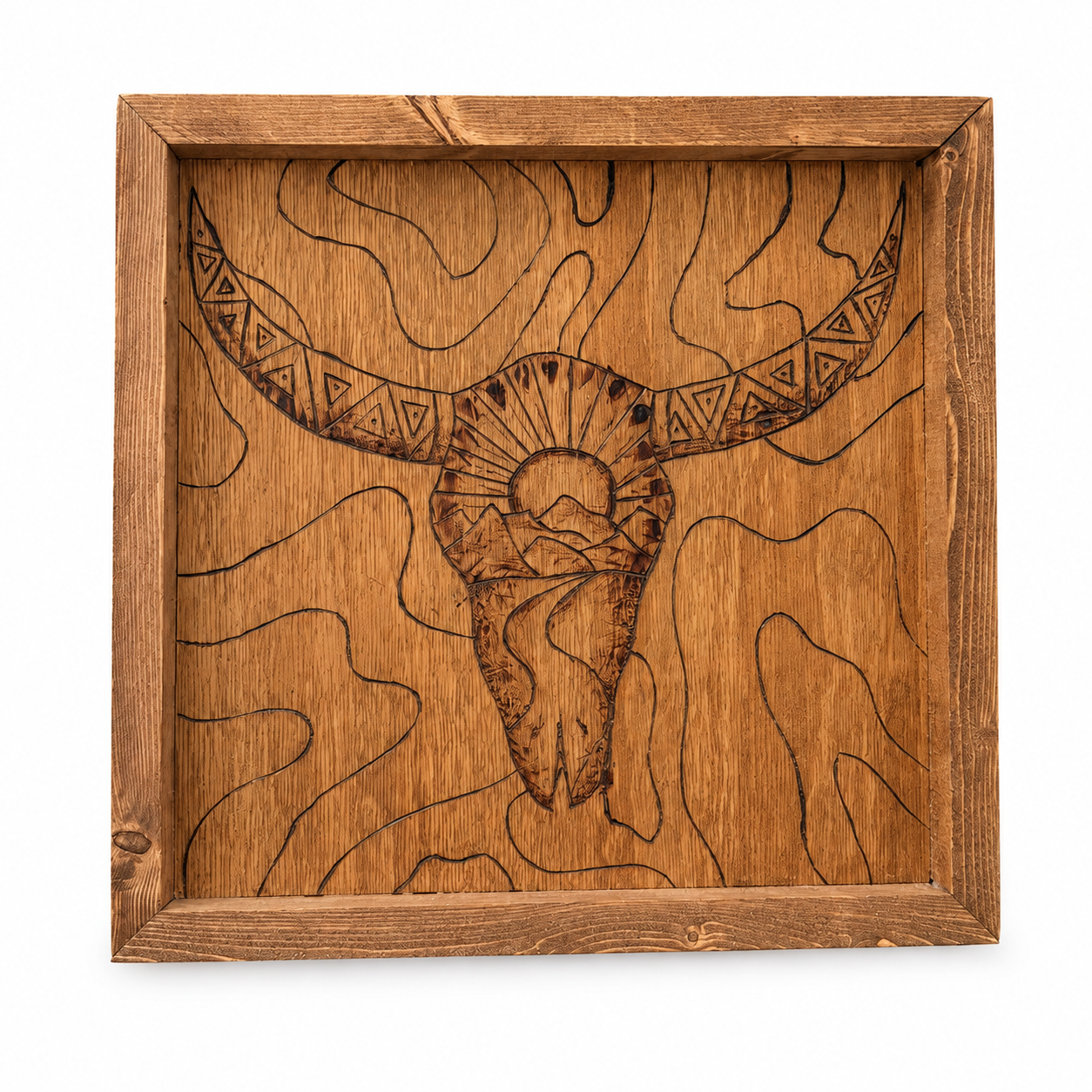 Wooden wall art depicting a stylized bull skull with geometric horn patterns, a setting sun, and mountain scenery in a carved design.
