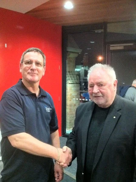 The first EPCSG Men's Health Forum, held in 2012. Inaugural guest speaker/MC, Les Twentyman (d. 2024), outreach worker for the Open Family/20th Man Fund and beloved Melbourne identity, alongside EPCSG convener, Robert Peters.