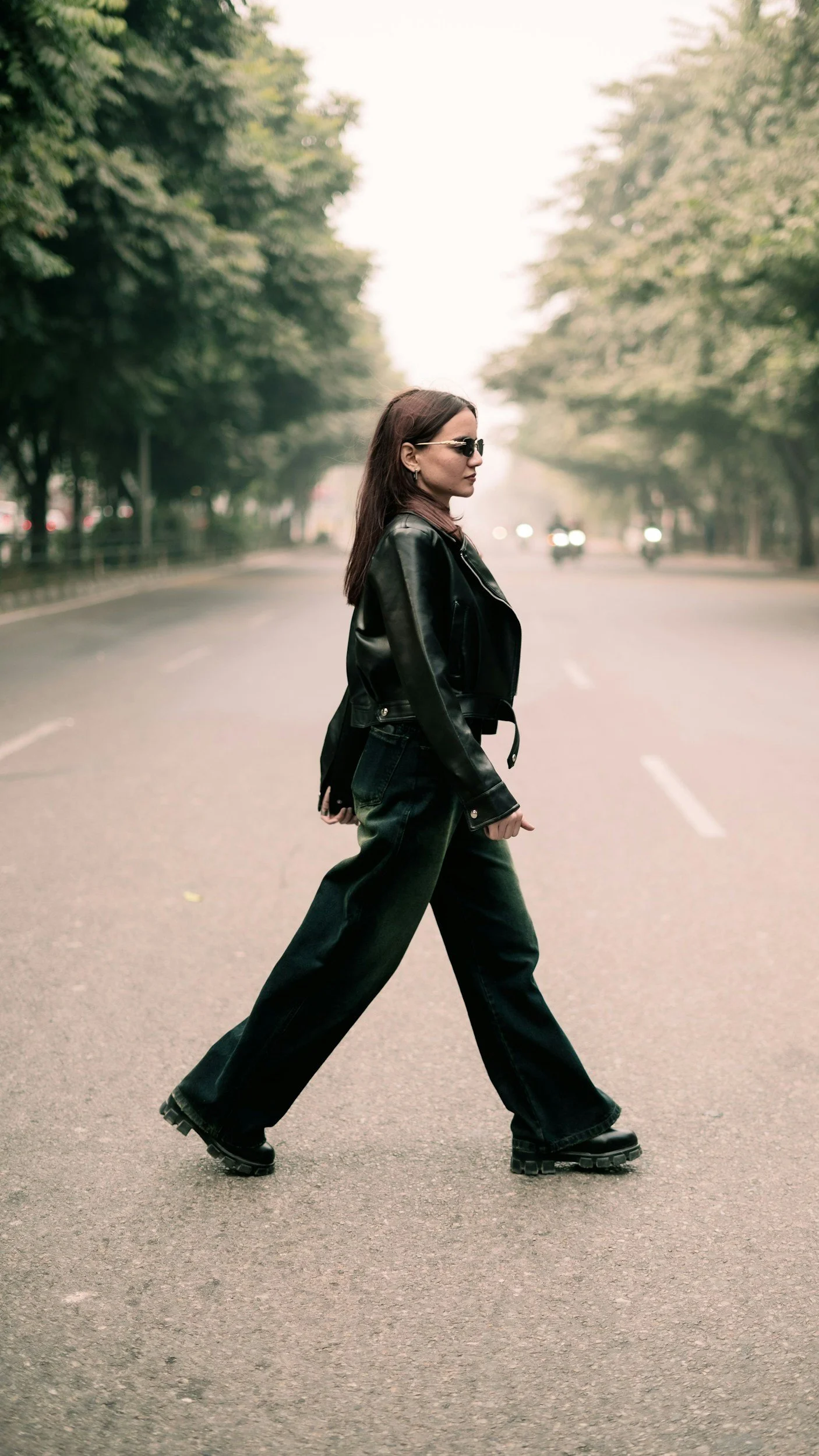 A woman walking across the street