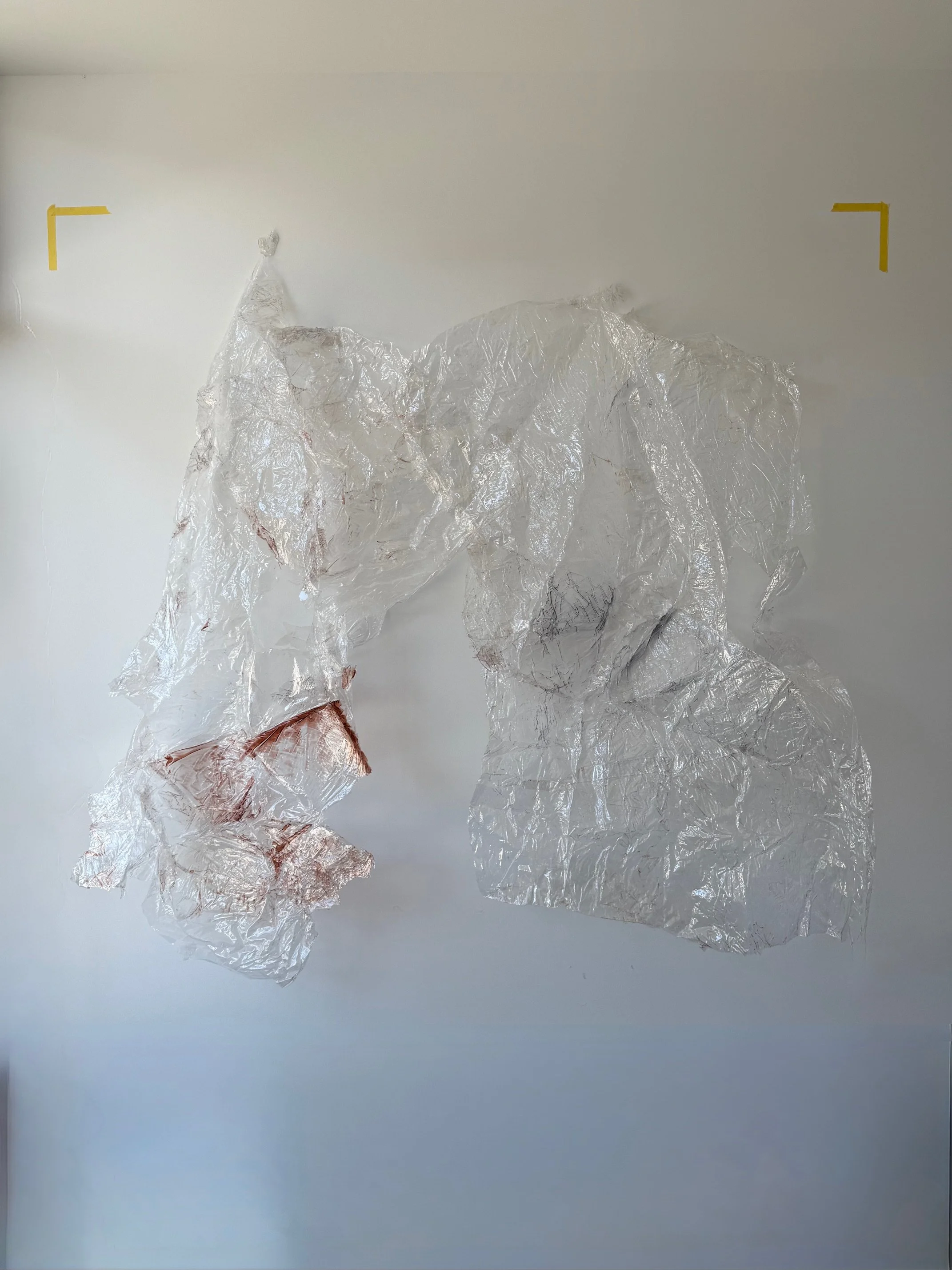 Crumpled PVC plastic, resin and pigments holding space suspended in space on a white surface.