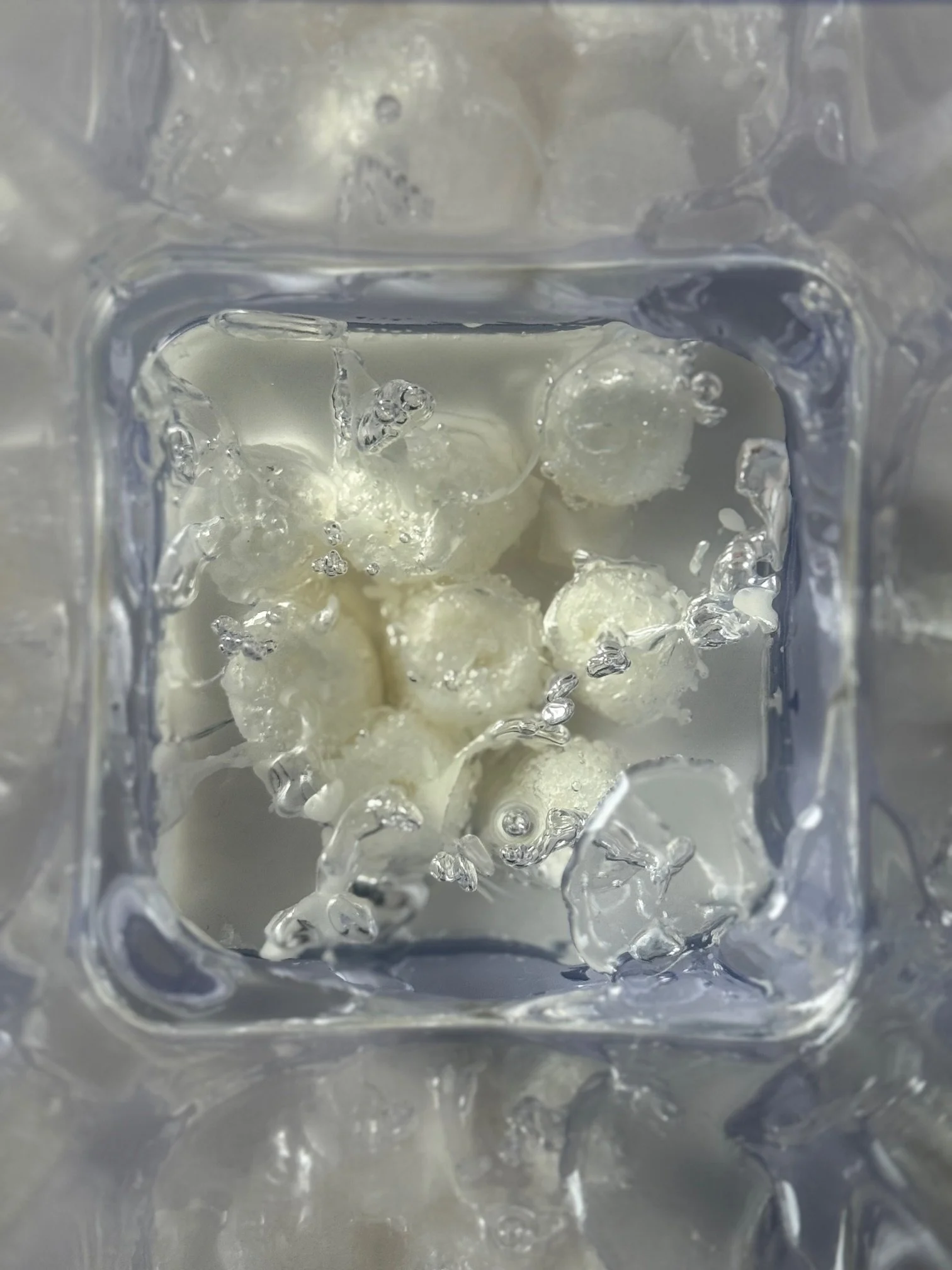 Observer effect.  Alone, unobserved Energy.
2025.
Recycled packing material, wax, Resin, PVC container.