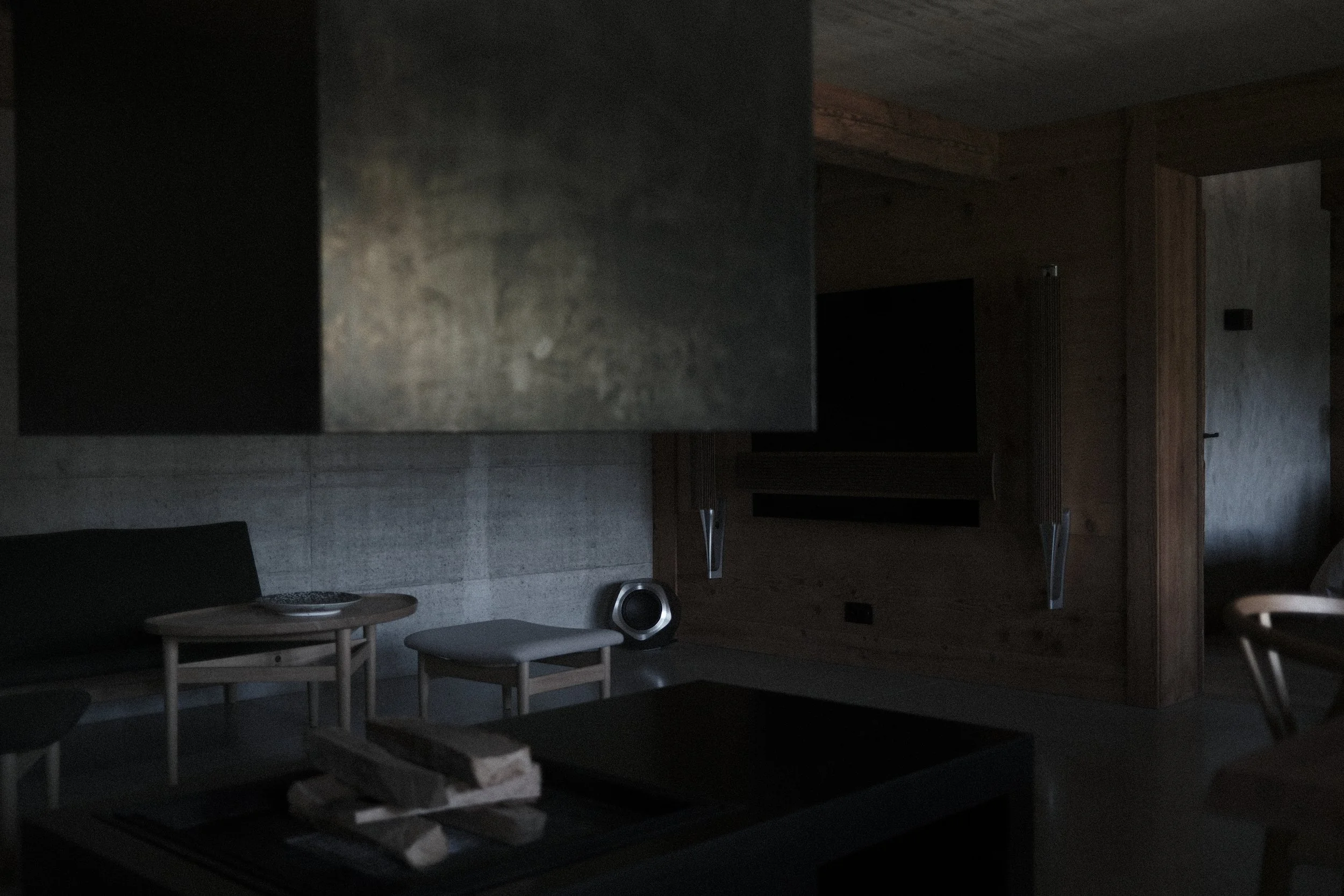 The lounge at Haus Mannenberg, a quiet shared living space with fireplace where guests can read, relax and gather in the Bernese Oberland near Gstaad.