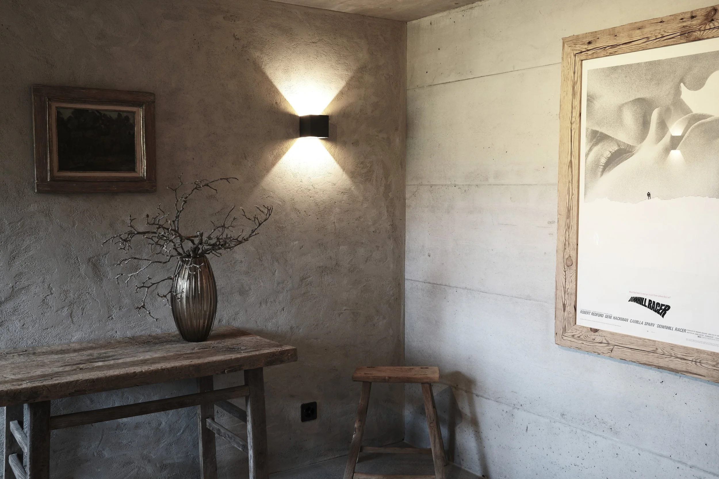 Entrance hall at Haus Mannenberg featuring handcrafted timber furniture, lime-plastered walls and carefully curated artwork.