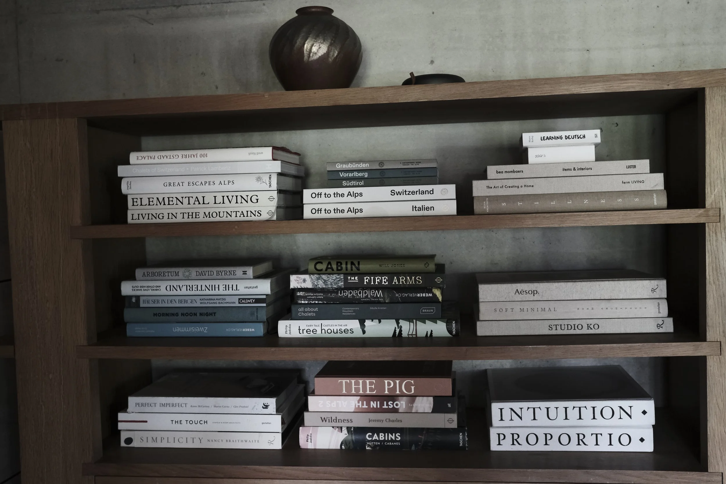 Curated library at Haus Mannenberg featuring architecture, design and travel books.