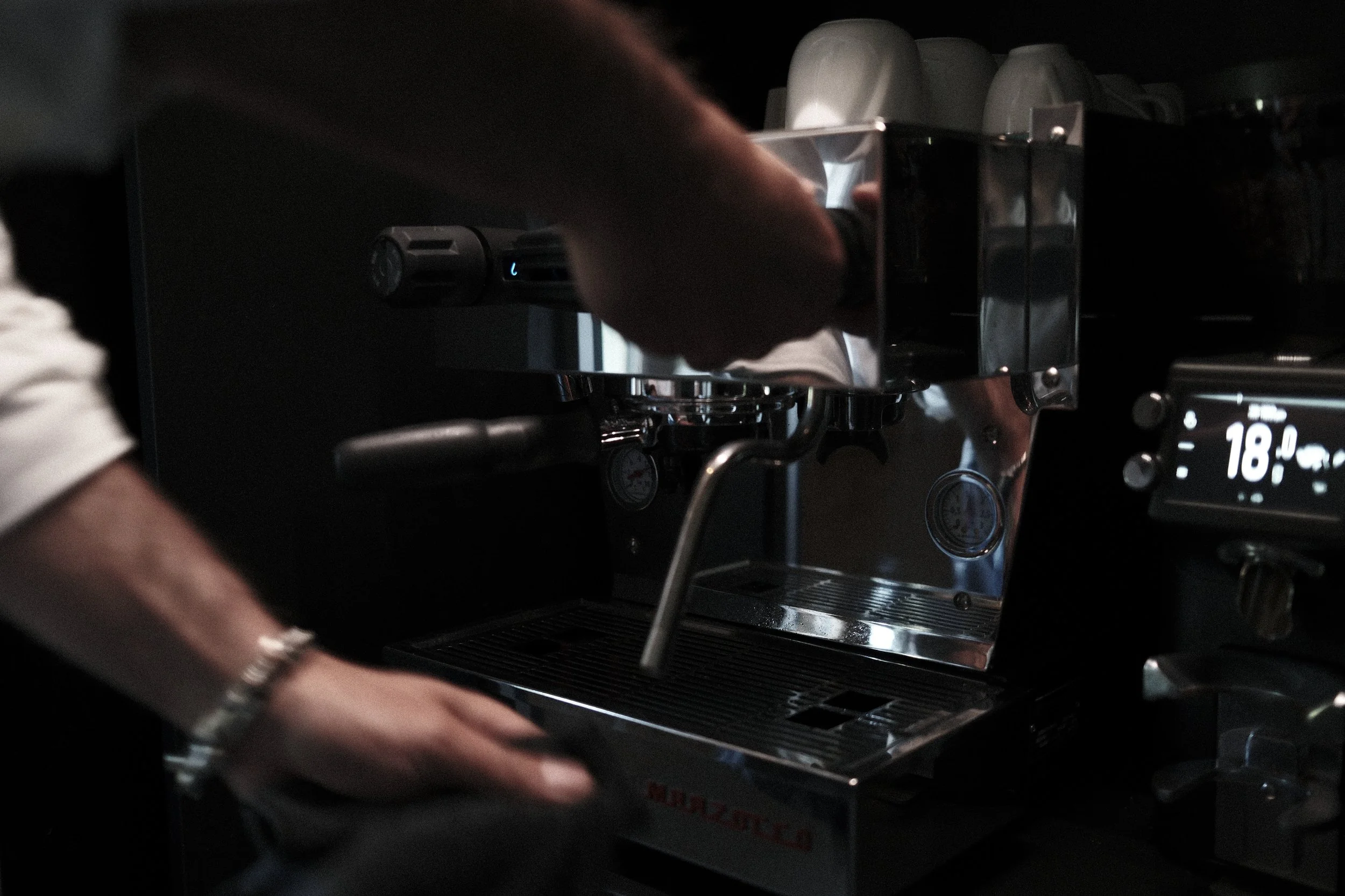 Preparing a morning coffee on a La Marzocco espresso machine during breakfast at Haus Mannenberg, a boutique guesthouse near Gstaad in the Bernese Oberland.