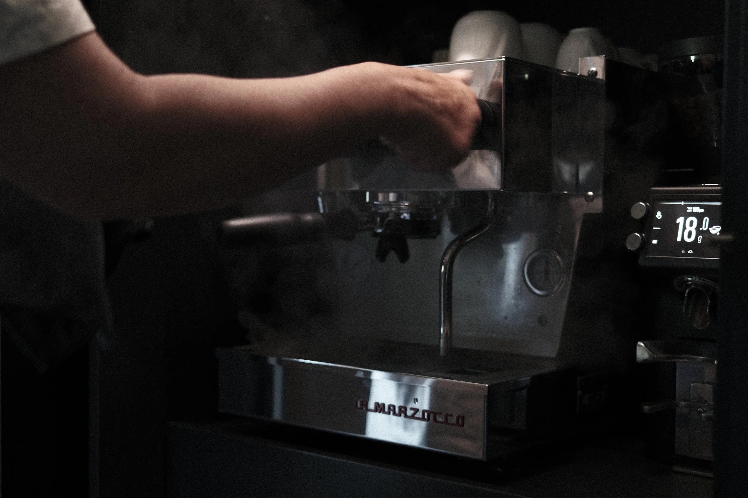 Preparing MAME specialty coffee on a La Marzocco espresso machine during a slow morning at Haus Mannenberg in the Bernese Oberland.