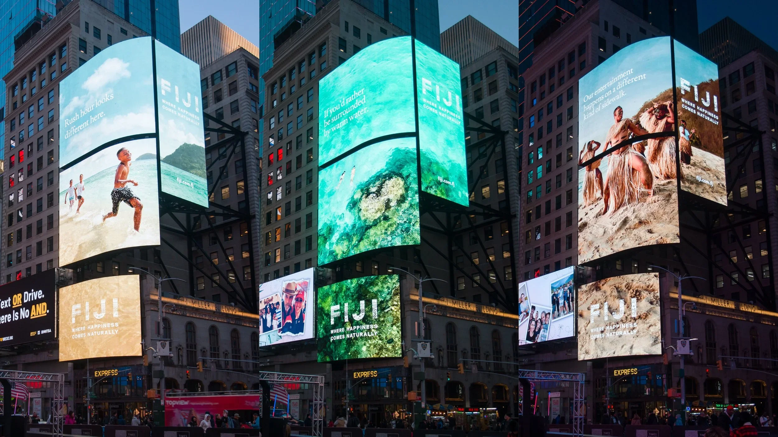 Three digital billboards on a city building at night displaying advertisements for Fiji, featuring images of children playing and nature scenes with text promoting the brand.