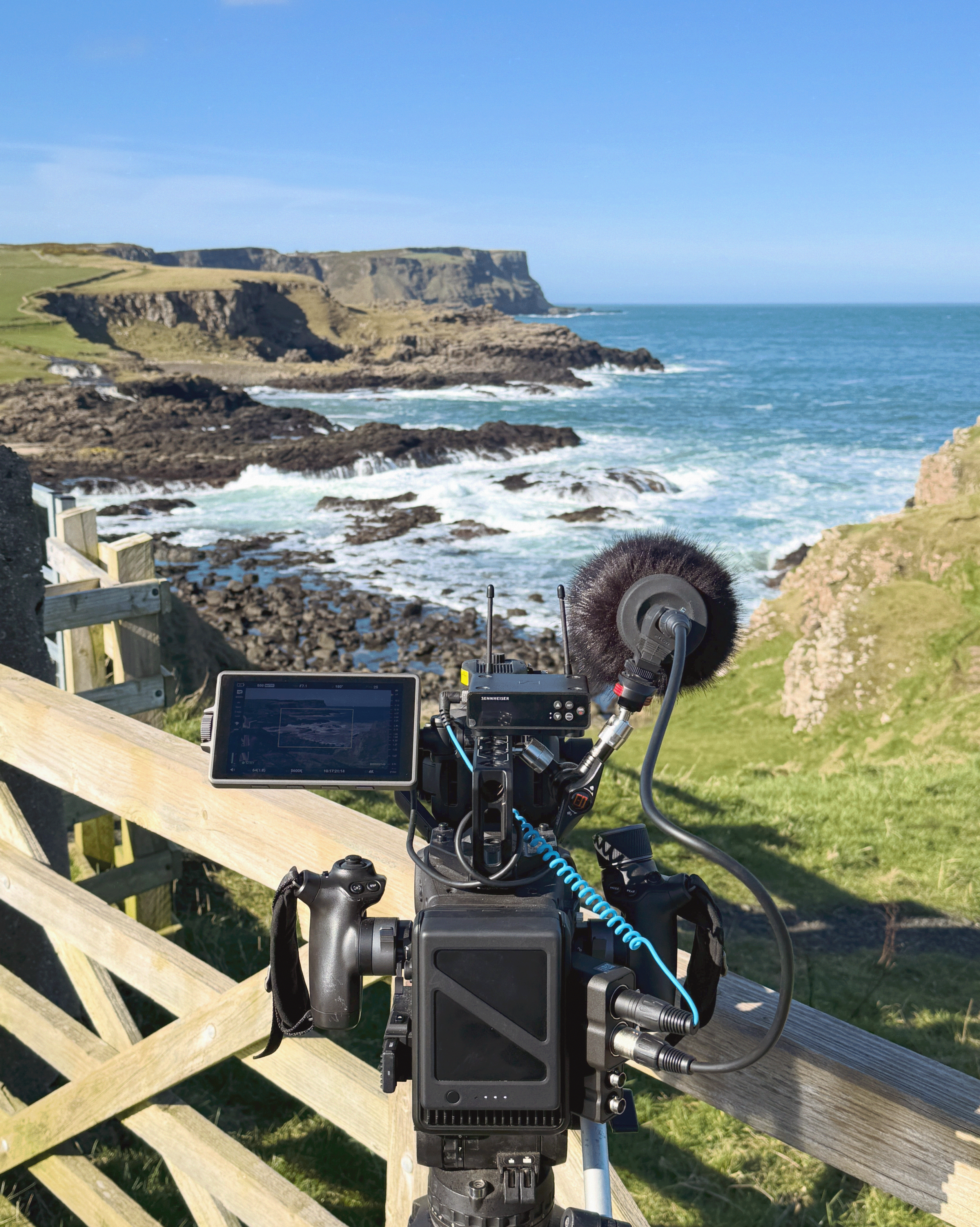 A professional documentary film camera setup overlooking a coastal landscape, representing Directed by Good's cinematic approach to heritage, cultural and purpose-driven storytelling.