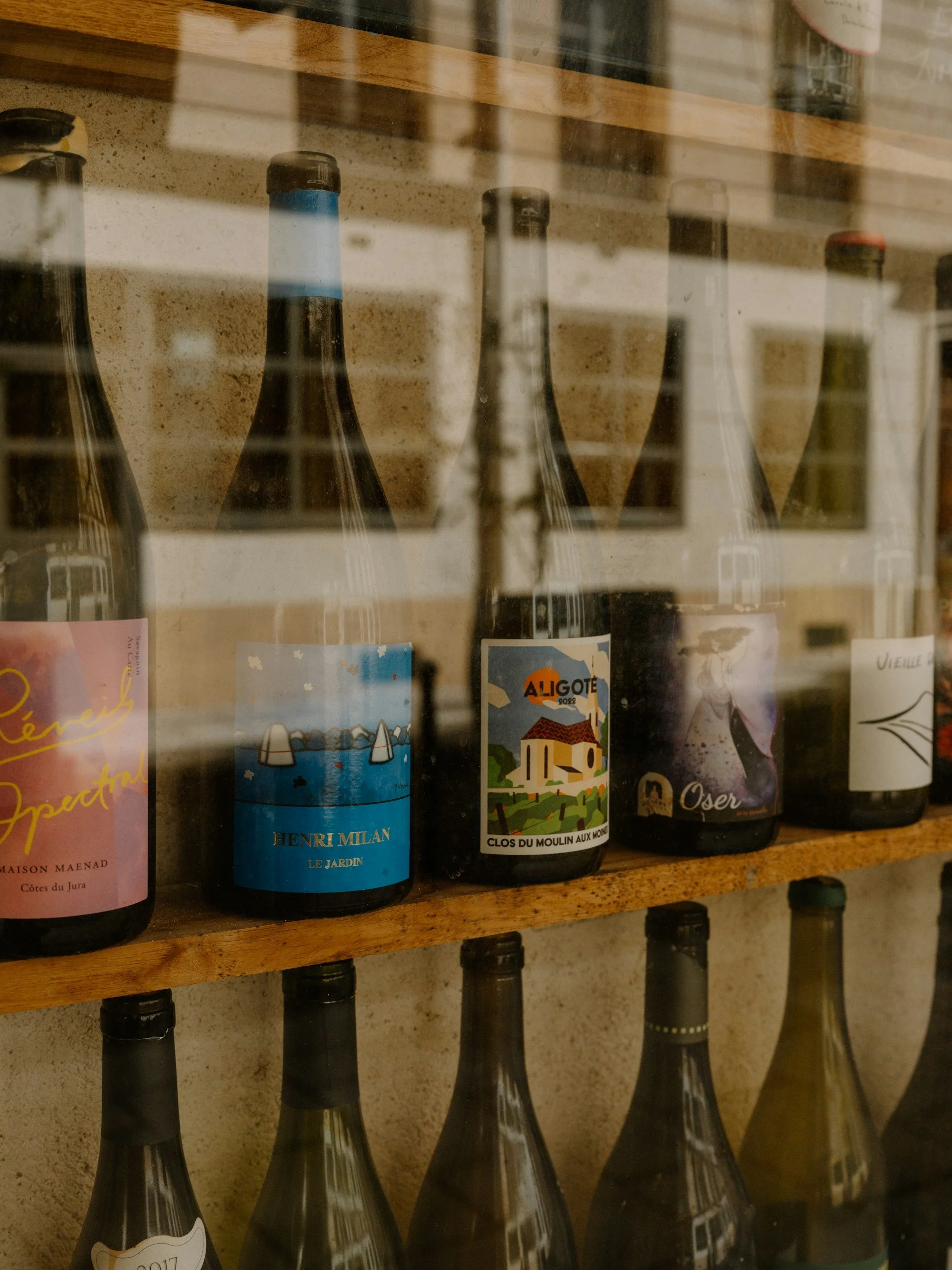 Close up of vintage wine bottles on wooden shelf
