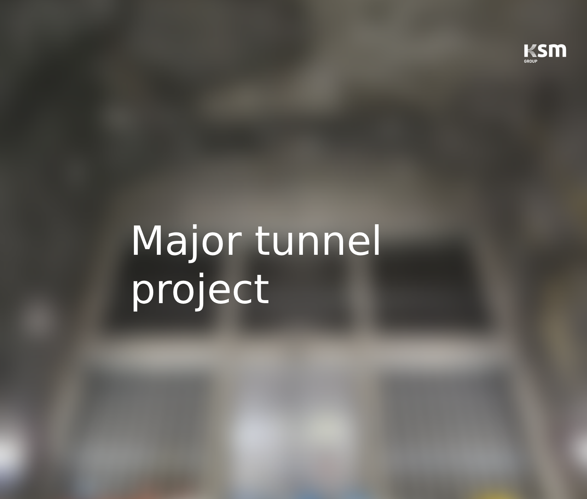 Blurred background with the text 'Major tunnel project' and a logo 'KSM GROUP' in the top right corner.