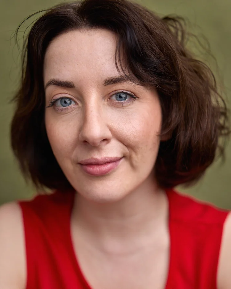 Annabel Logan, actor, wearing a red top.