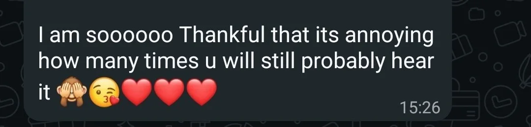 Screenshot of a WhatsApp message expressing gratitude and love, with emojis of a kissing face, hearts, and a face with hearts.