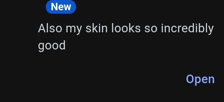 Text message window with a blue "New" label, the message "Also my skin looks so incredibly good", and a blue "Open" button.