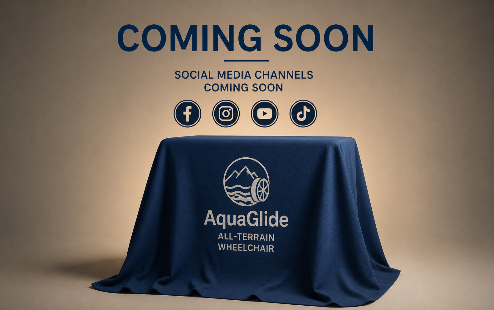 Announcement of upcoming AquaGlide all-terrain wheelchair, with social media icons for Facebook, Instagram, YouTube, and TikTok, on a table draped with a blue cloth featuring the AquaGlide logo.