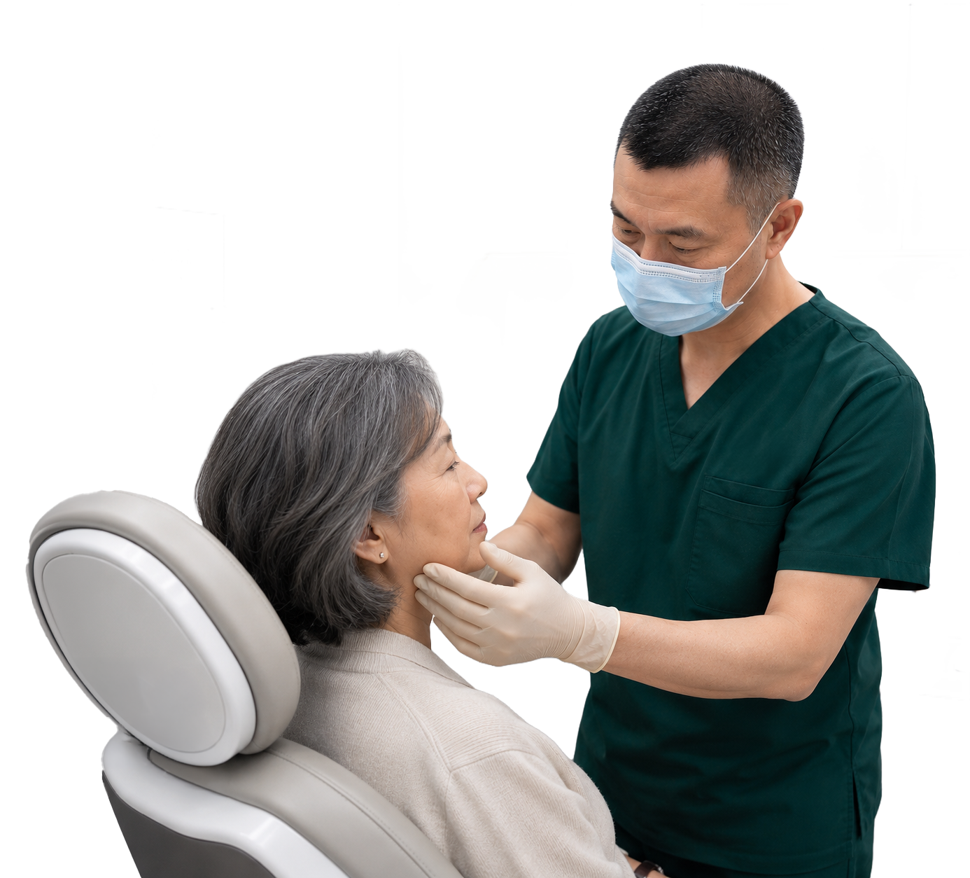 A healthcare professional in green scrubs and a face mask examines an elderly woman's mouth in a medical setting.