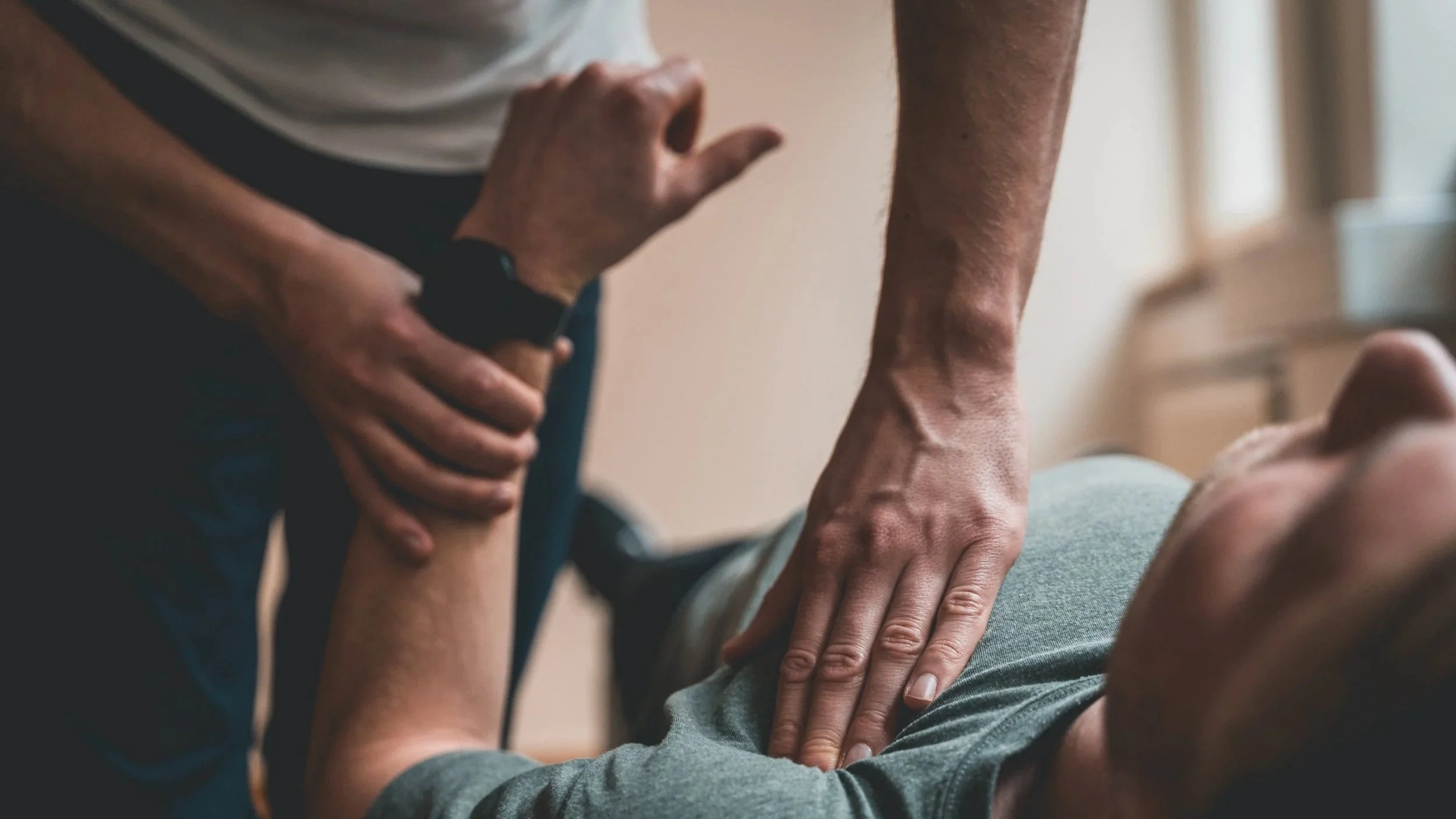 A person performing cardiopulmonary resuscitation (CPR) on another individual, focusing on chest compressions.
