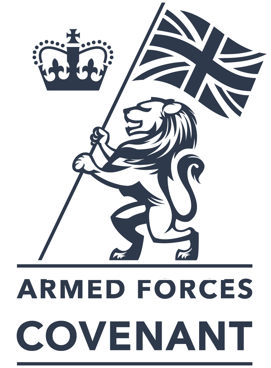 A stylized lion holding a Union Jack flag in one paw, with a crown symbol above, and the words "Armed Forces Covenant" below.