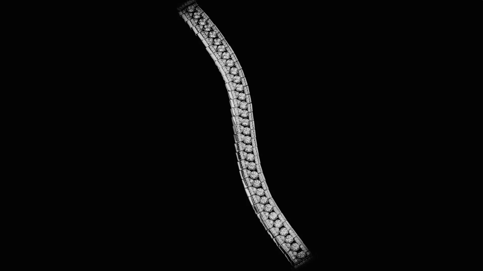Dettaglio di un raffinato bracciale snodato in oro bianco e diamanti incastonati su sfondo nero per la collezione Ralph Lauren High Jewelry.